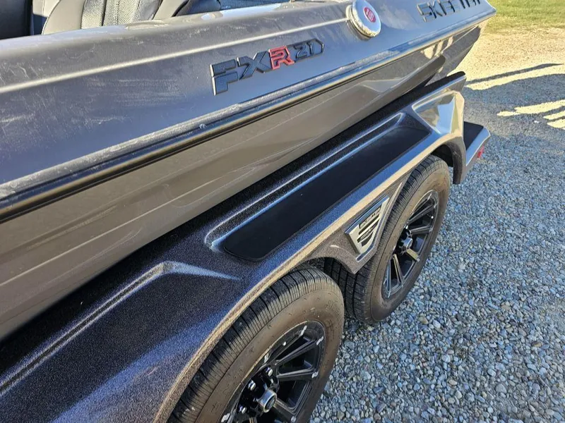 Slide: The Image of 2025 Skeeter FXR21L boat on trailer, black finish, close-up view. - 2