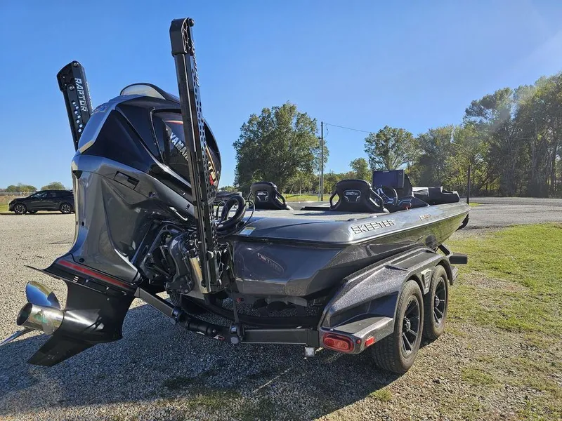 Slide: The Image of 2025 Skeeter FXR21L bass boat with powerful outboard motor, parked outdoors. - 4