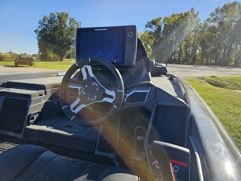 Slide: The Image of 2025 Skeeter FXR21L boat dashboard with steering wheel and navigation system. - 6