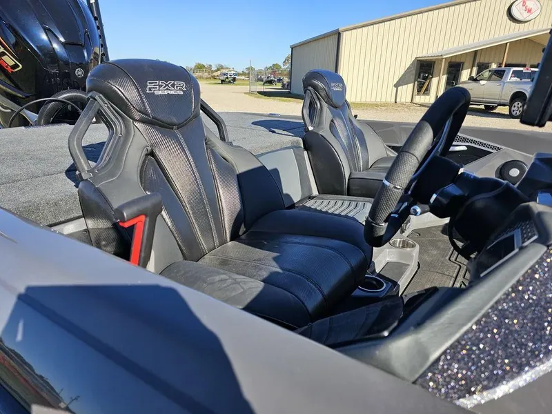 Slide: The Image of 2025 Skeeter FXR21L boat interior with sleek black seats and modern steering wheel. - 9