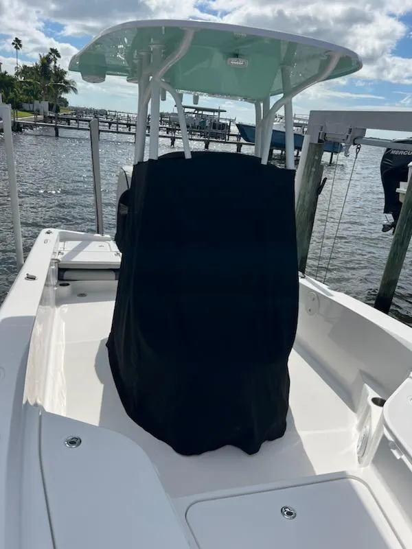 Slide: The Image of 2021 Aquasport 230 Pro Bay boat with T-top, docked by the water. - 10