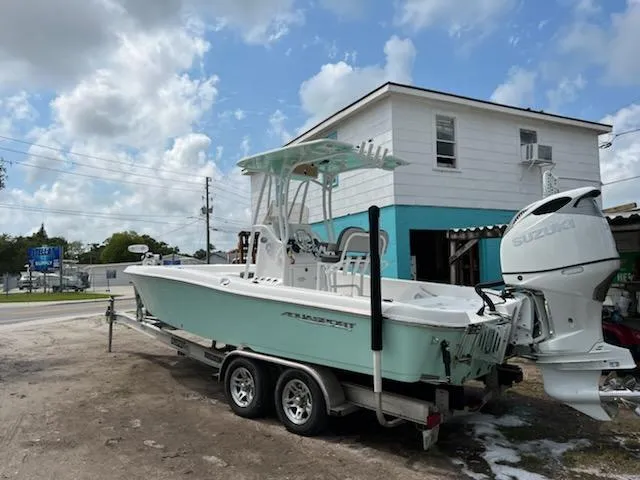 Slide: The Image of 2021 Aquasport 230 Pro Bay boat on trailer with Suzuki outboard motor. - 12