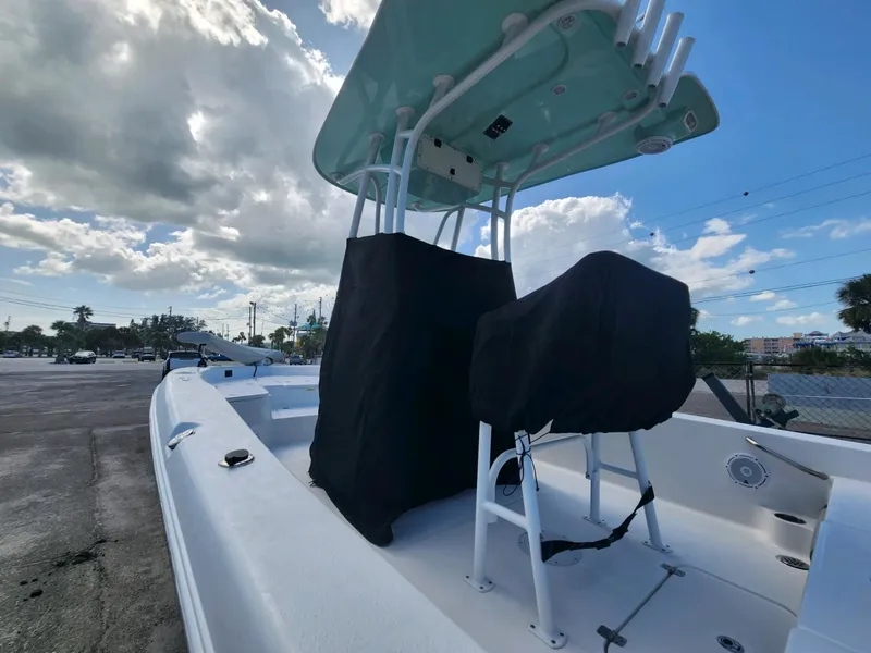 Slide: The Image of 2021 Aquasport 230 Pro Bay boat with T-top, parked under cloudy sky. - 4