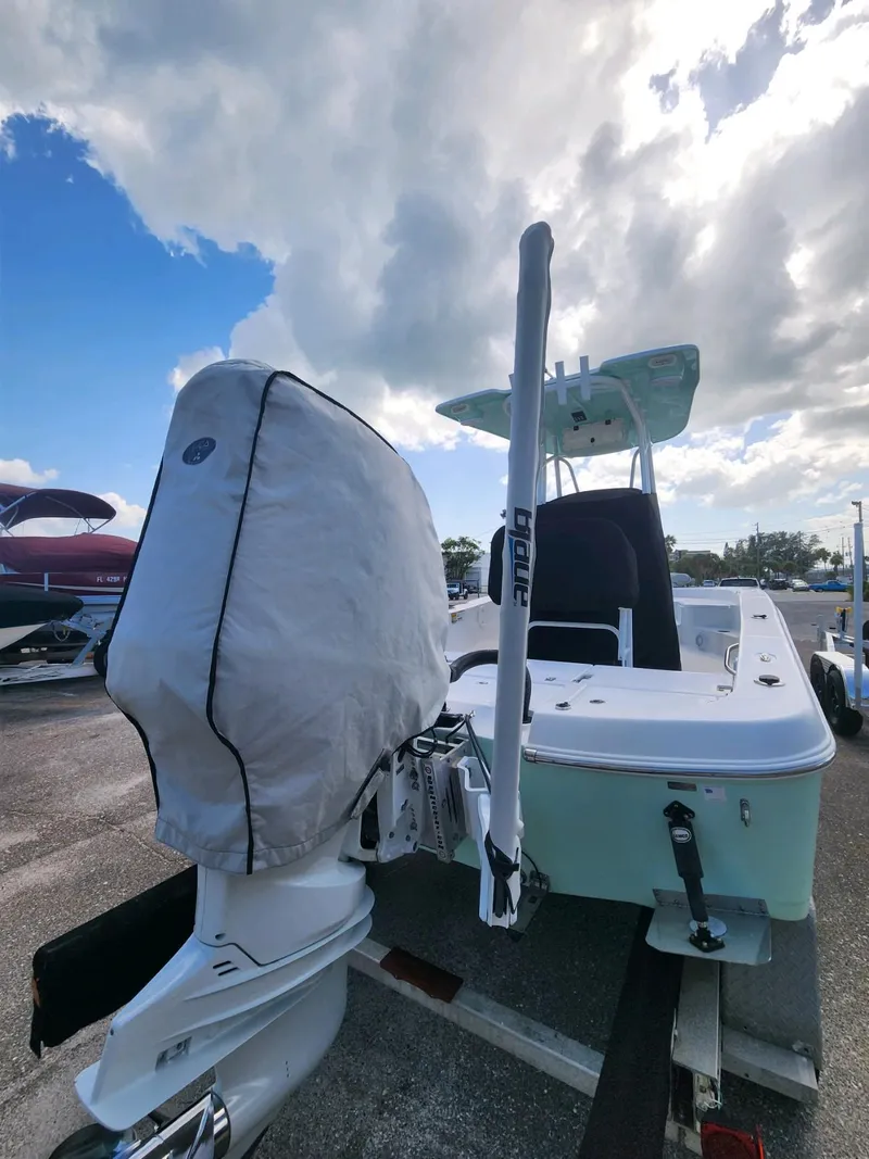 Slide: The Image of 2021 Aquasport 230 Pro Bay boat on trailer under cloudy sky. - 5