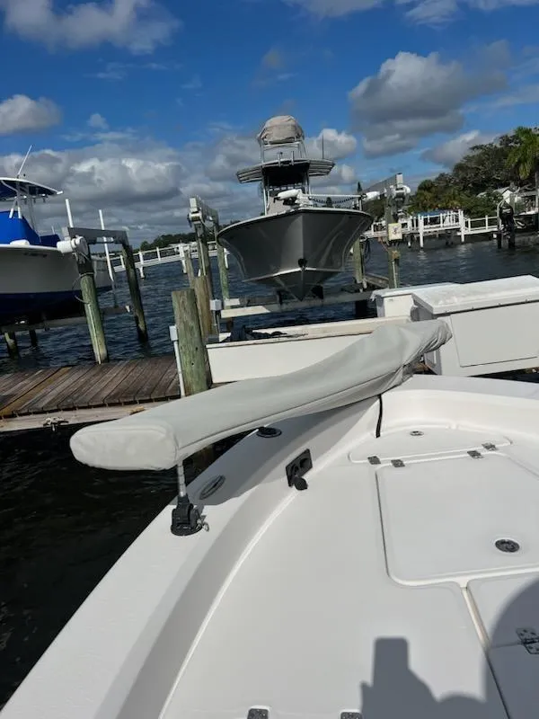 Slide: The Image of 2021 Aquasport 230 Pro Bay boat docked at marina under blue sky. - 6