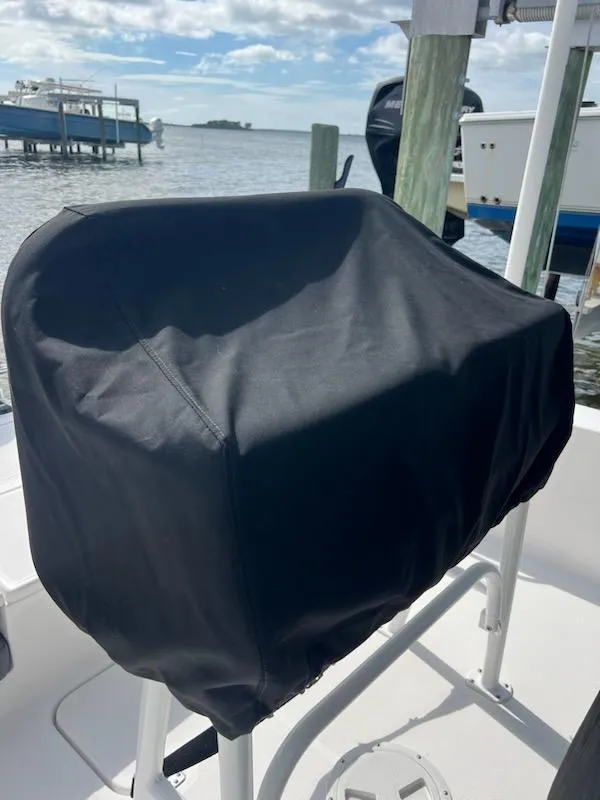 Slide: The Image of 2021 Aquasport 230 Pro Bay boat with covered console, docked by the water. - 8