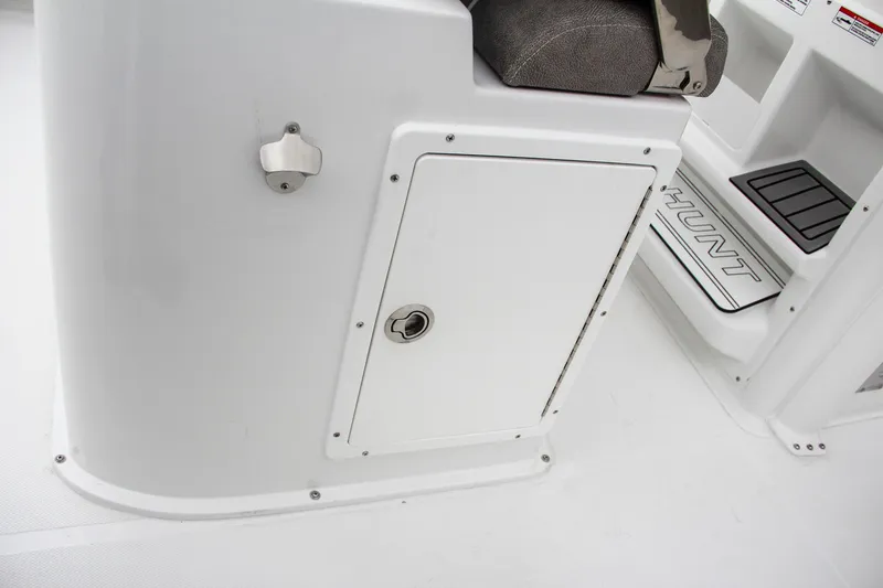 Slide: The Image of 2025 Sea Hunt Gamefish 27 storage compartment with open door, showcasing interior space. - 28