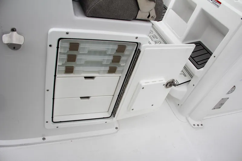 Slide: The Image of 2025 Sea Hunt Gamefish 27 boat interior, featuring storage compartment and seating area. - 29