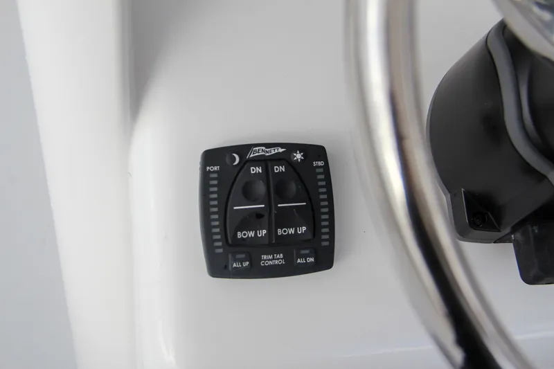 Slide: The Image of 2025 Sea Hunt Gamefish 27 helm controls with dual cup holders. - 37