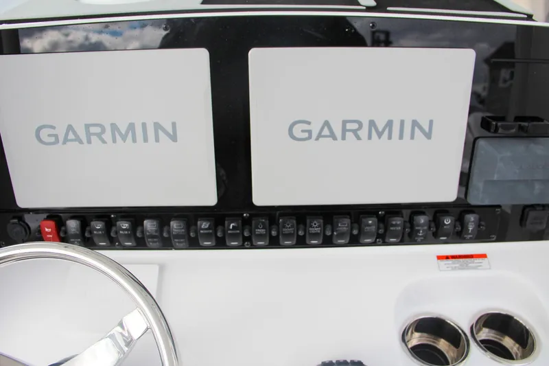 Slide: The Image of Bennett trim tab control on 2025 Sea Hunt Gamefish 27 boat dashboard. - 38