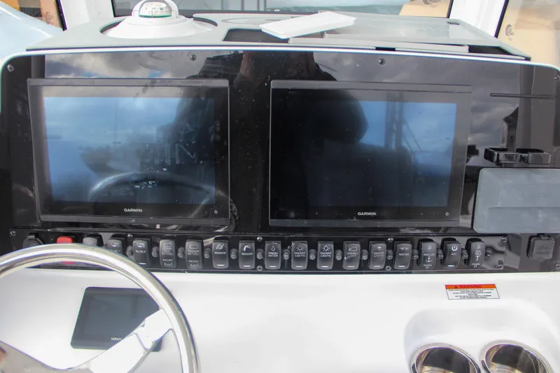 Slide: The Image of Dual Garmin displays on 2025 Sea Hunt Gamefish 27 boat dashboard. - 39