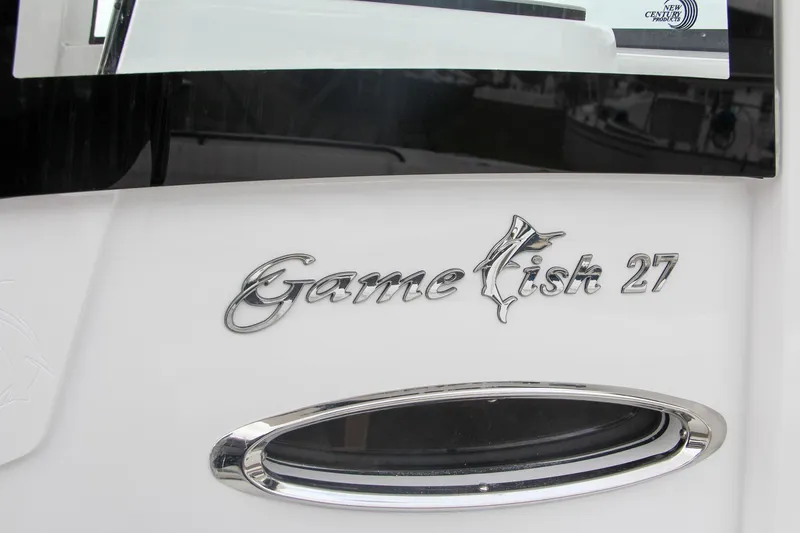 Slide: The Image of 2025 Sea Hunt Gamefish 27 boat interior with rod holders and seating. - 6