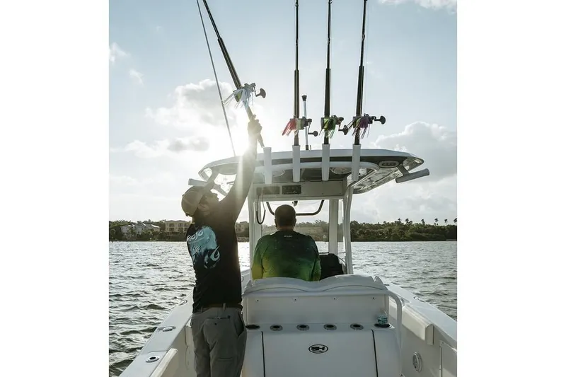 Slide: The Image of 2025 Sea Hunt Gamefish 27 boat with Yamaha engines, docked in a marina. - 66