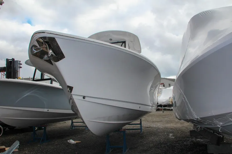 Slide: The Image of 2025 Sea Hunt Gamefish 27 Forward Seating with open storage compartment and cushioned seats. - 9