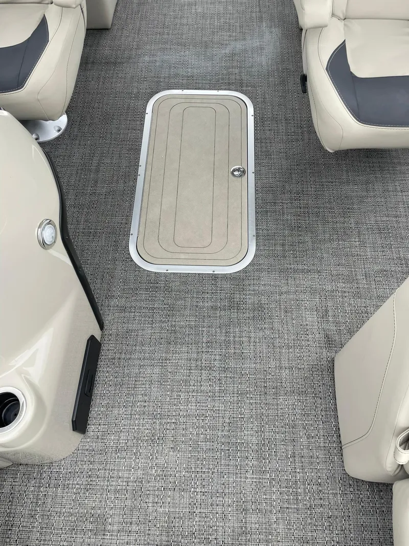Slide: The Image of 2024 Barletta ARIA 22QC boat interior with gray carpet and beige seating. - 15