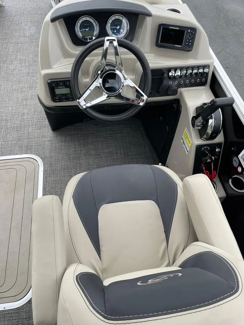 Slide: The Image of 2024 Barletta ARIA 22QC boat interior with steering wheel and dashboard controls. - 18