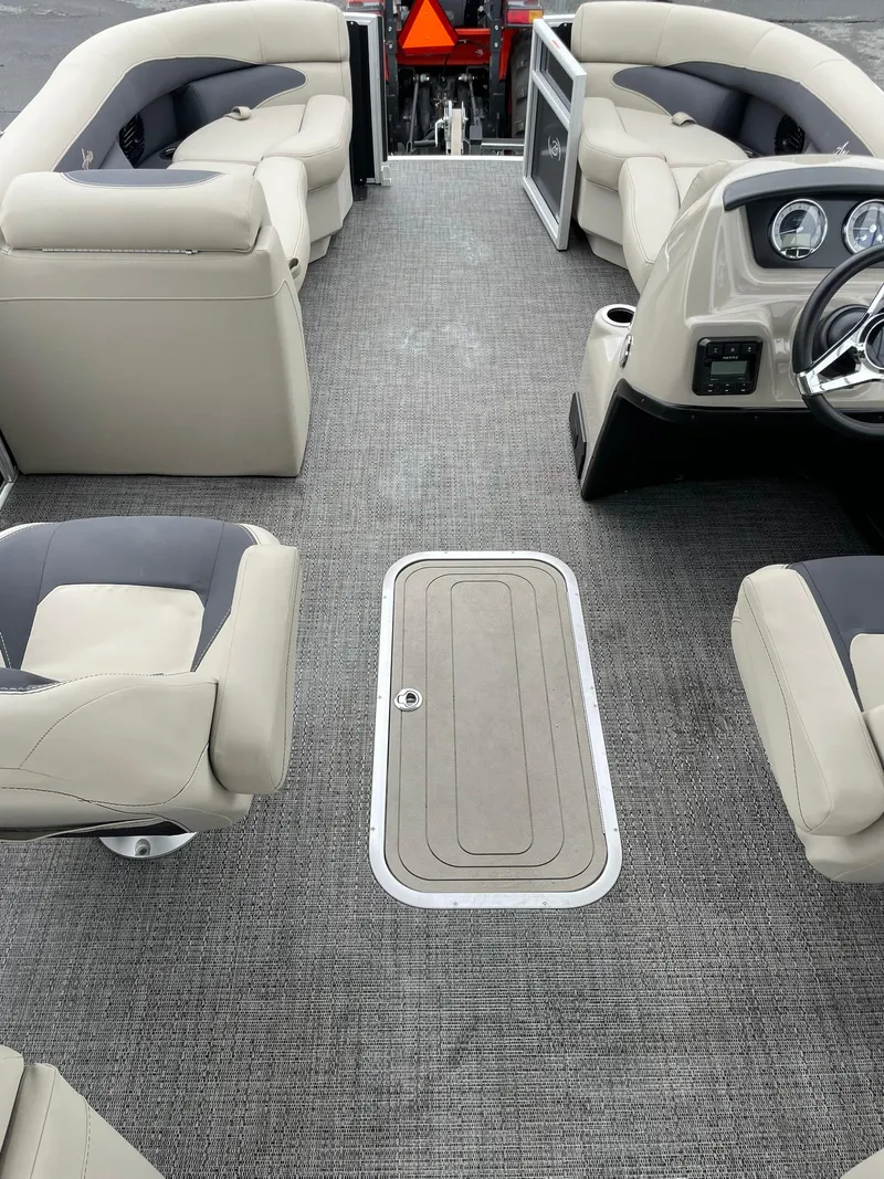 Slide: The Image of 2024 Barletta ARIA 22QC pontoon boat interior with plush seating and modern dashboard. - 22