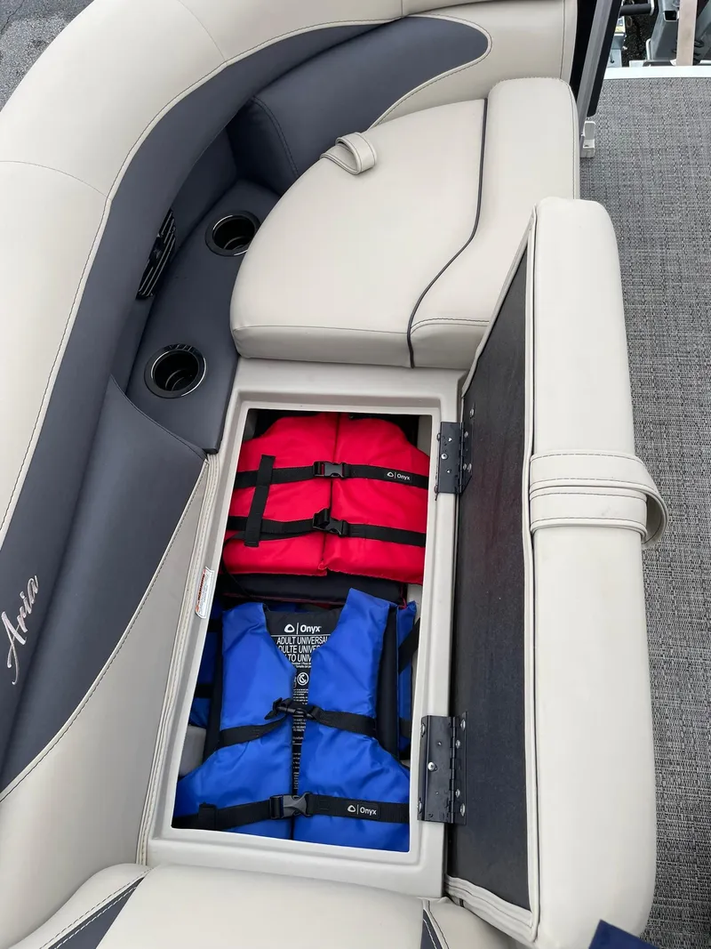 Slide: The Image of 2024 Barletta ARIA 22QC boat seat storage with red and blue life jackets. - 29