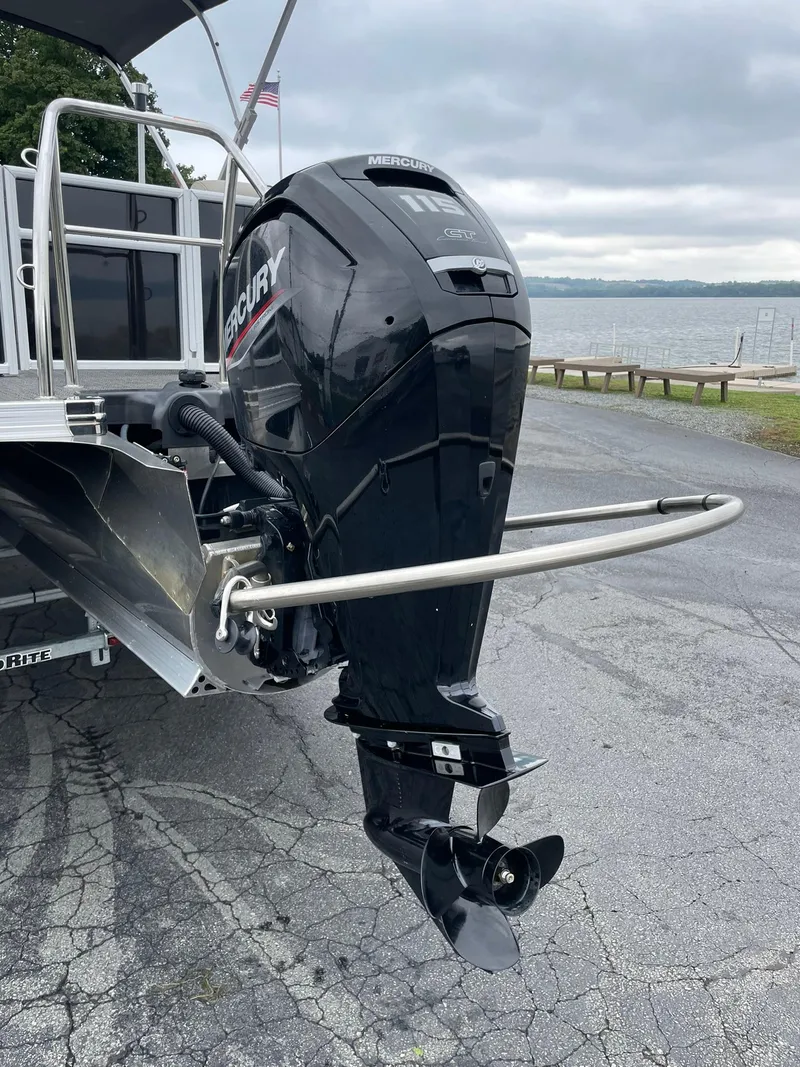 Slide: The Image of 2024 Barletta ARIA 22QC with Mercury outboard motor, docked by a lake. - 8