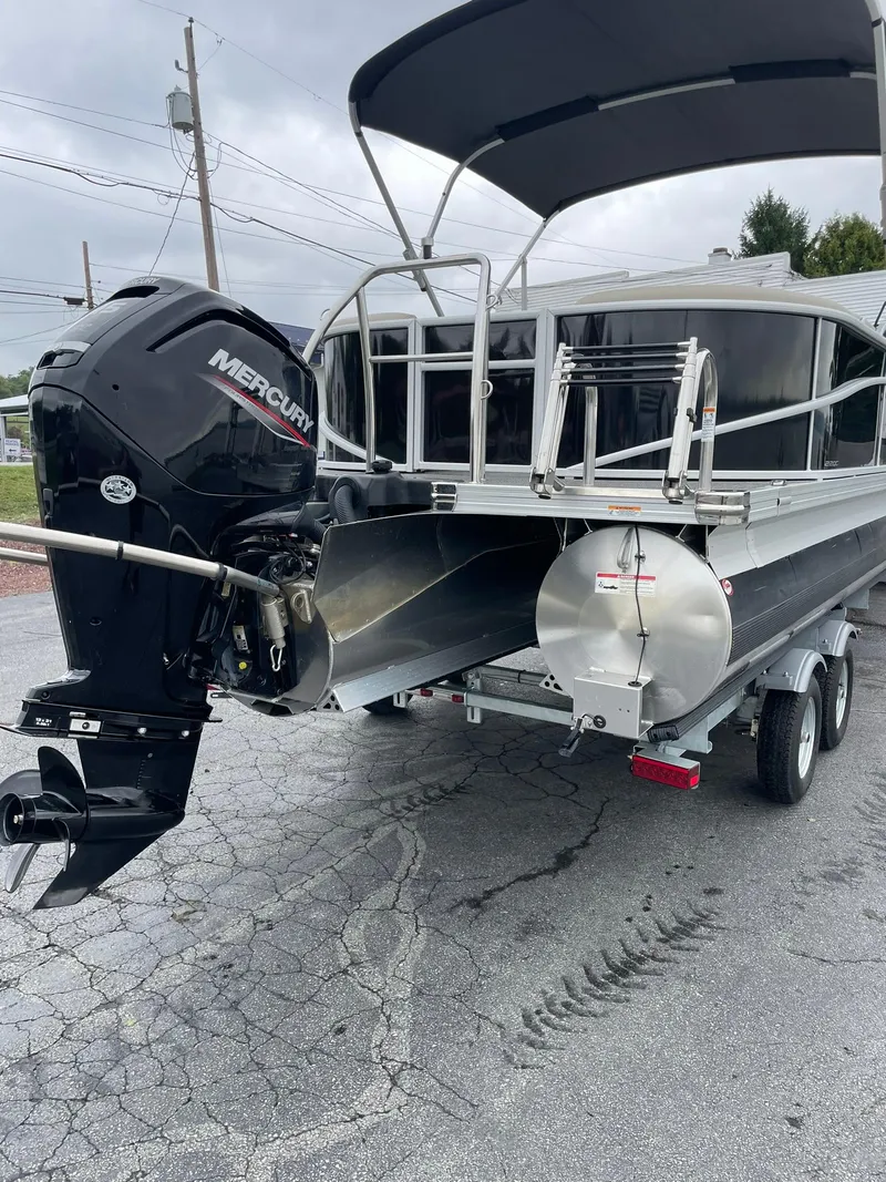 Slide: The Image of 2024 Barletta ARIA 22QC pontoon boat with Mercury outboard motor on trailer. - 9