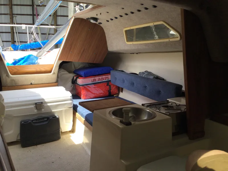 Slide: The Image of Interior of a 1988 Precision 21 sailboat with seating, storage, and life jackets. - 10