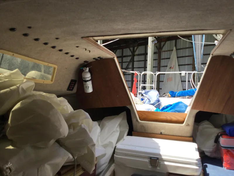 Slide: The Image of Interior of 1988 Precision 21 sailboat with sails and equipment stored inside. - 11