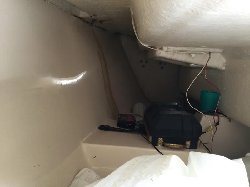 Slide: The Image of Interior of a 1988 Precision 21 sailboat, showing storage area with wiring and equipment. - 12