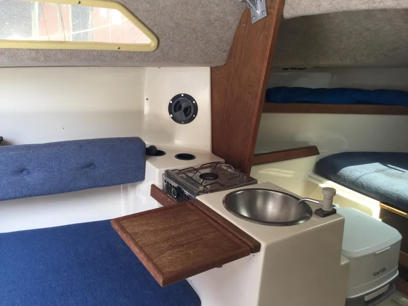 Slide: The Image of Interior of a 1988 Precision 21 sailboat with compact kitchen and seating area. - 8