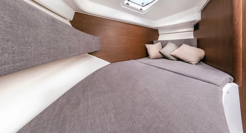 Slide: The Image of 2023 Beneteau Antares 8 cabin interior with cozy bedding and cushions. - 10
