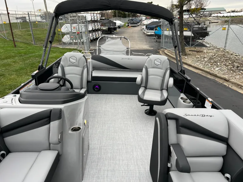 Slide: The Image of 2025 South Bay S224 UL pontoon boat with sleek gray interior and comfortable seating. - 10