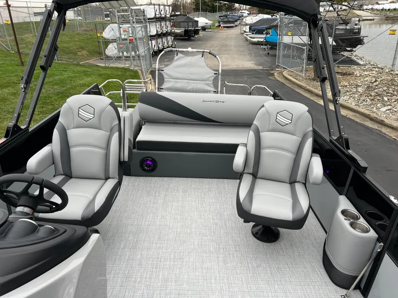 Slide: The Image of 2025 South Bay S224 UL pontoon boat interior with gray seating and modern design. - 11