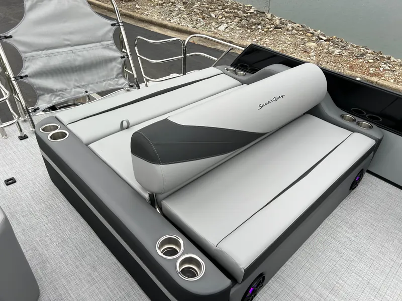 Slide: The Image of 2025 South Bay S224 UL boat seating with cup holders, sleek design, and waterfront view. - 14