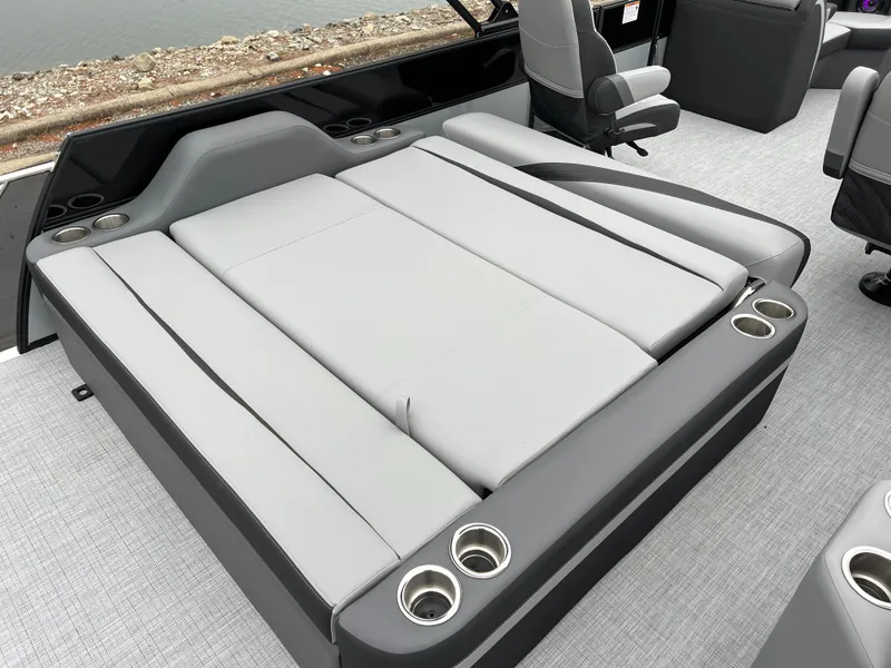 Slide: The Image of 2025 South Bay S224 UL boat interior with gray seating and cup holders. - 16