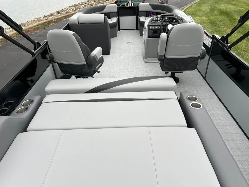 Slide: The Image of 2025 South Bay S224 UL pontoon boat interior with plush seating and modern dashboard. - 19