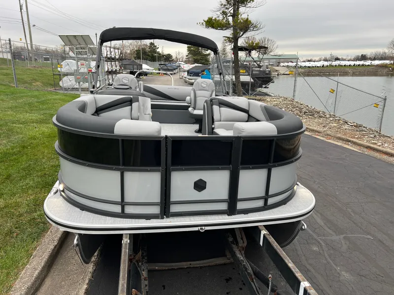 Slide: The Image of 2025 South Bay S224 UL pontoon boat on trailer by waterfront. - 2