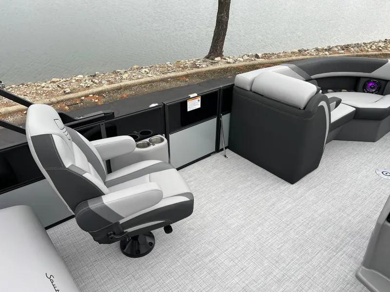 Slide: The Image of 2025 South Bay S224 UL pontoon boat interior with gray seating and lake view. - 20