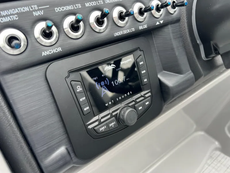 Slide: The Image of 2025 South Bay S224 UL boat dashboard with control panel and radio display. - 22