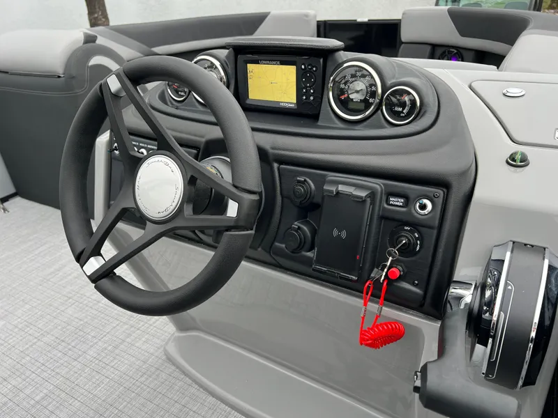 Slide: The Image of 2025 South Bay S224 UL boat dashboard with steering wheel and control panel. - 24