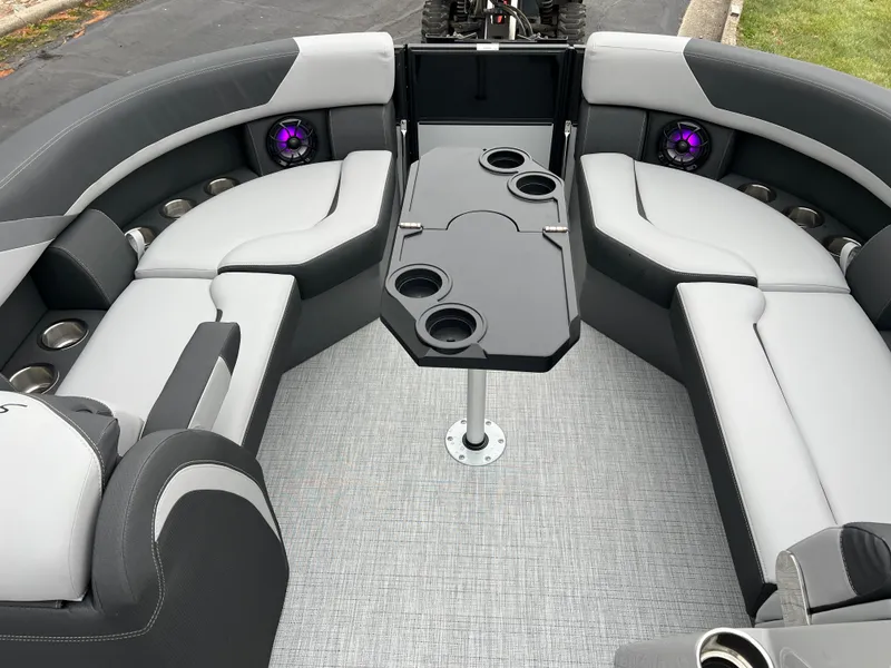 Slide: The Image of 2025 South Bay S224 UL pontoon boat interior with gray seating and cup holders. - 26