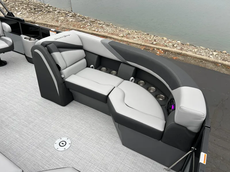 Slide: The Image of 2025 South Bay S224 UL pontoon boat with sleek gray seating and cup holders. - 7