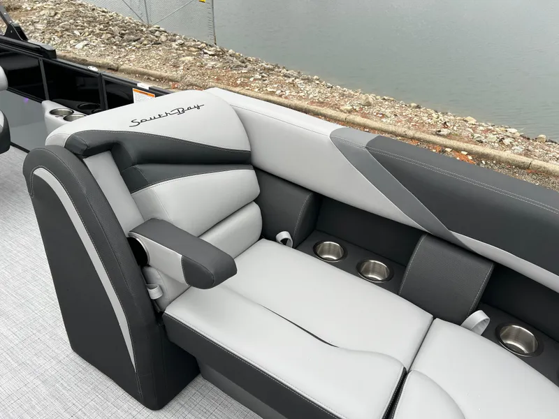 Slide: The Image of Luxurious seating on 2025 South Bay S224 UL pontoon boat by the water. - 9
