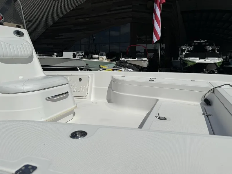 Slide: The Image of 2008 NauticStar 2200 Nauticbay boat interior with seating and American flag. - 19