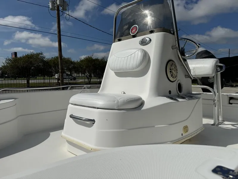 Slide: The Image of 2008 NauticStar 2200 Nauticbay boat with white seating and console under a blue sky. - 22