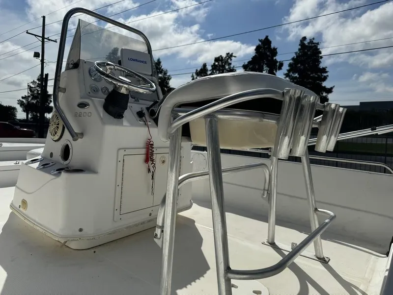 Slide: The Image of 2008 NauticStar 2200 Nauticbay boat console with steering wheel and seating under blue sky. - 6