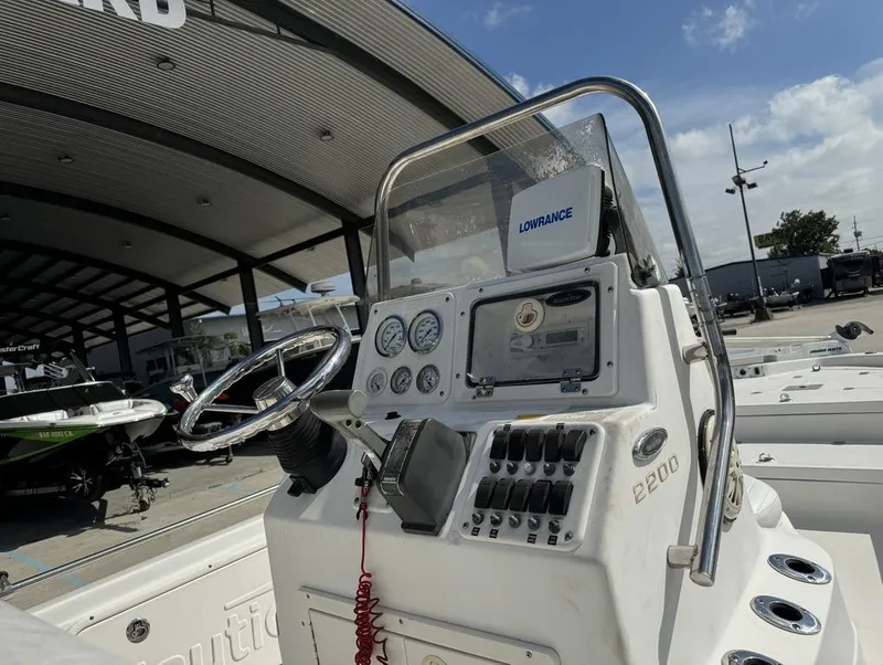 Slide: The Image of 2008 NauticStar 2200 Nauticbay boat dashboard with steering wheel and controls. - 7