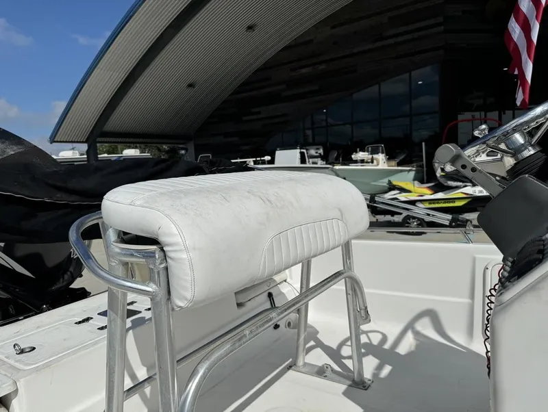 Slide: The Image of 2008 NauticStar 2200 Nauticbay boat interior with white seating and steering console. - 8
