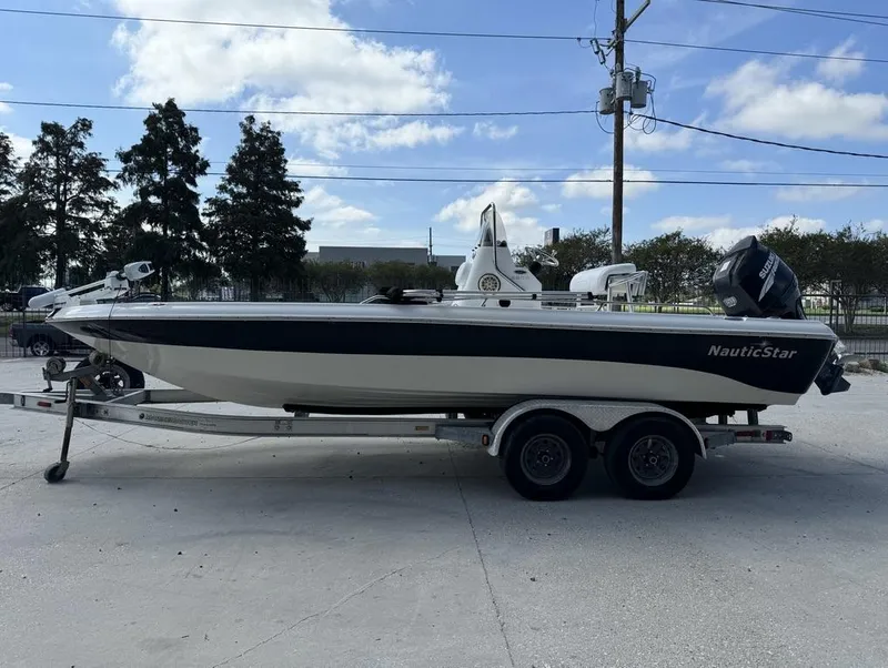 Slide: The Image of 2008 NauticStar 2200 Nauticbay boat on trailer, outdoor setting, clear sky. - 9