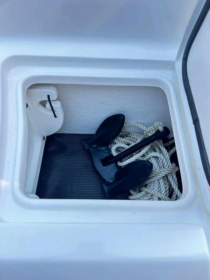 Slide: The Image of Anchor and rope storage in 2022 Sea Hunt Ultra 234 boat compartment. - 15