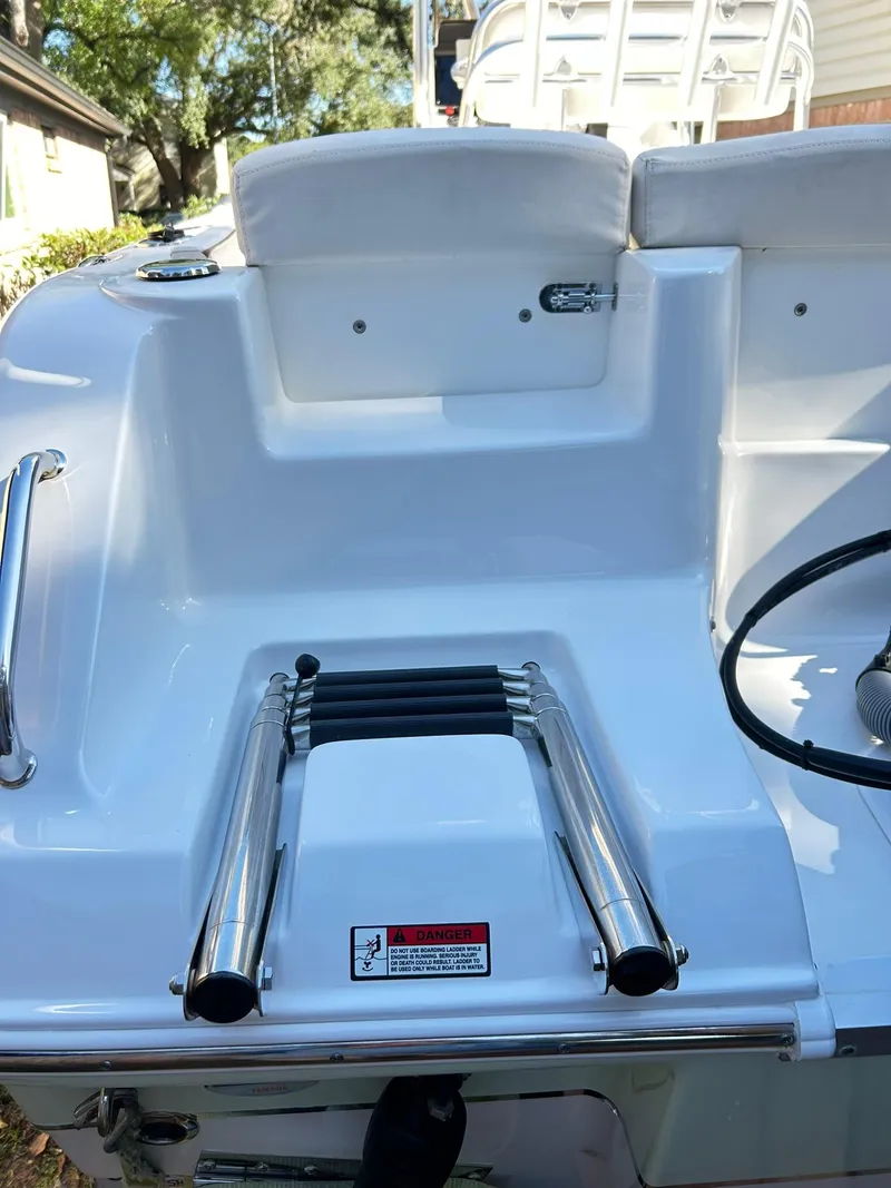 Slide: The Image of 2022 Sea Hunt Ultra 234 boat with stainless steel ladder and seating area. - 17