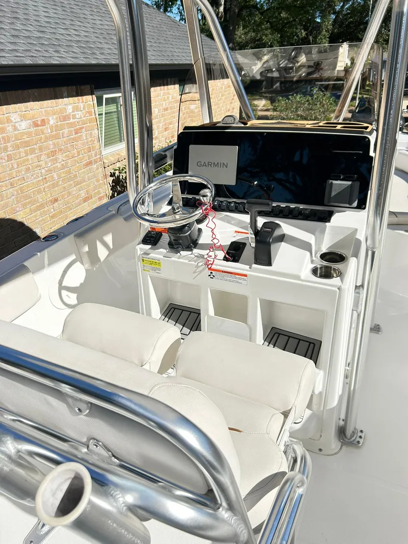 Slide: The Image of 2022 Sea Hunt Ultra 234 boat interior with Garmin navigation system and dual seating. - 18